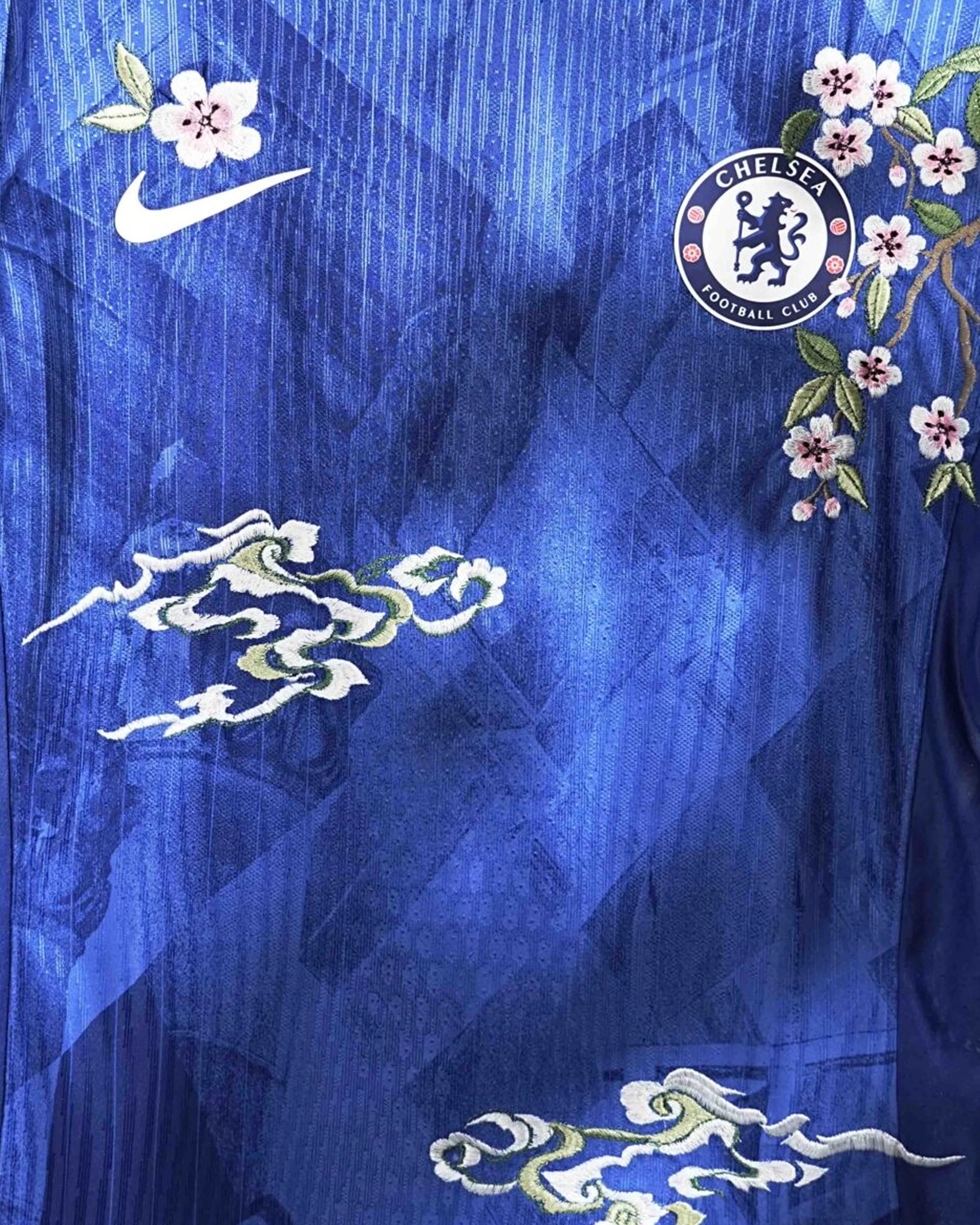 Close-up of the club crest on the Chelsea 'Blue London' Edition Jersey 2025-26, beautifully framed by intricate floral art.