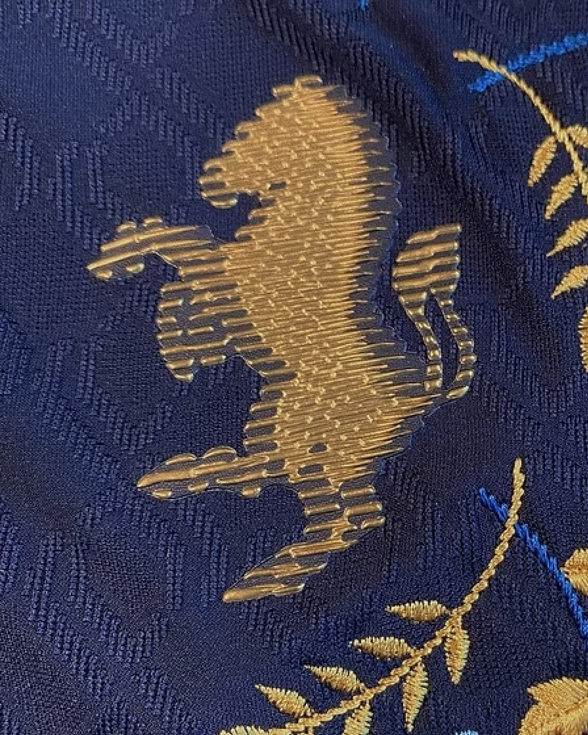 Close-up view of the gold logo crest on the Embroidered Juventus Third Jersey 2024-25. Premium navy fabric with intricate stitching.