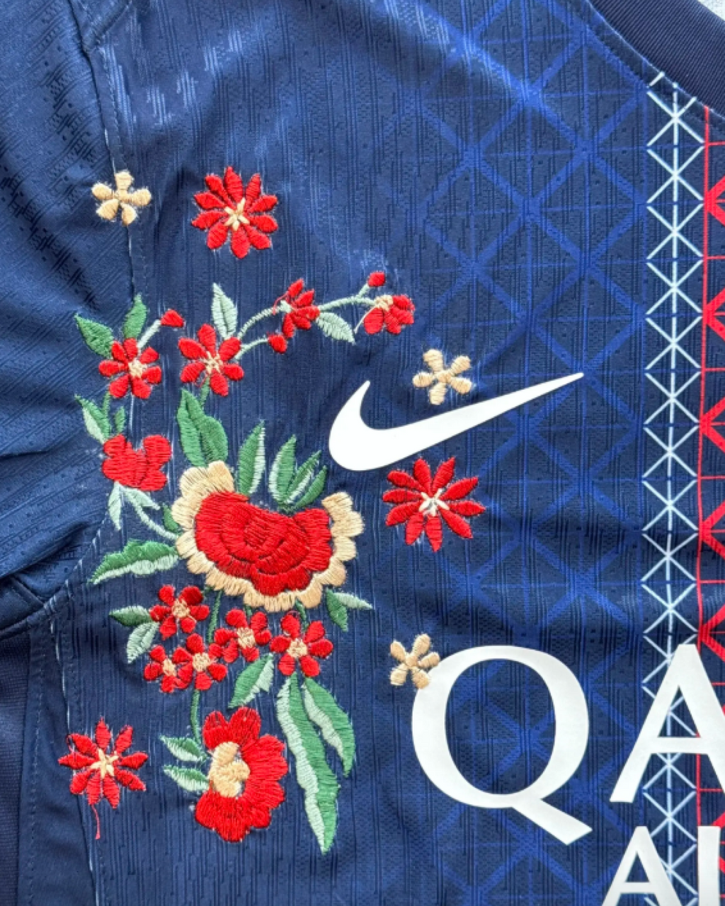 Detail of the floral embroidery on the Embroidered PSG Home Jersey 2025-26, showcasing vibrant colors and intricate design.