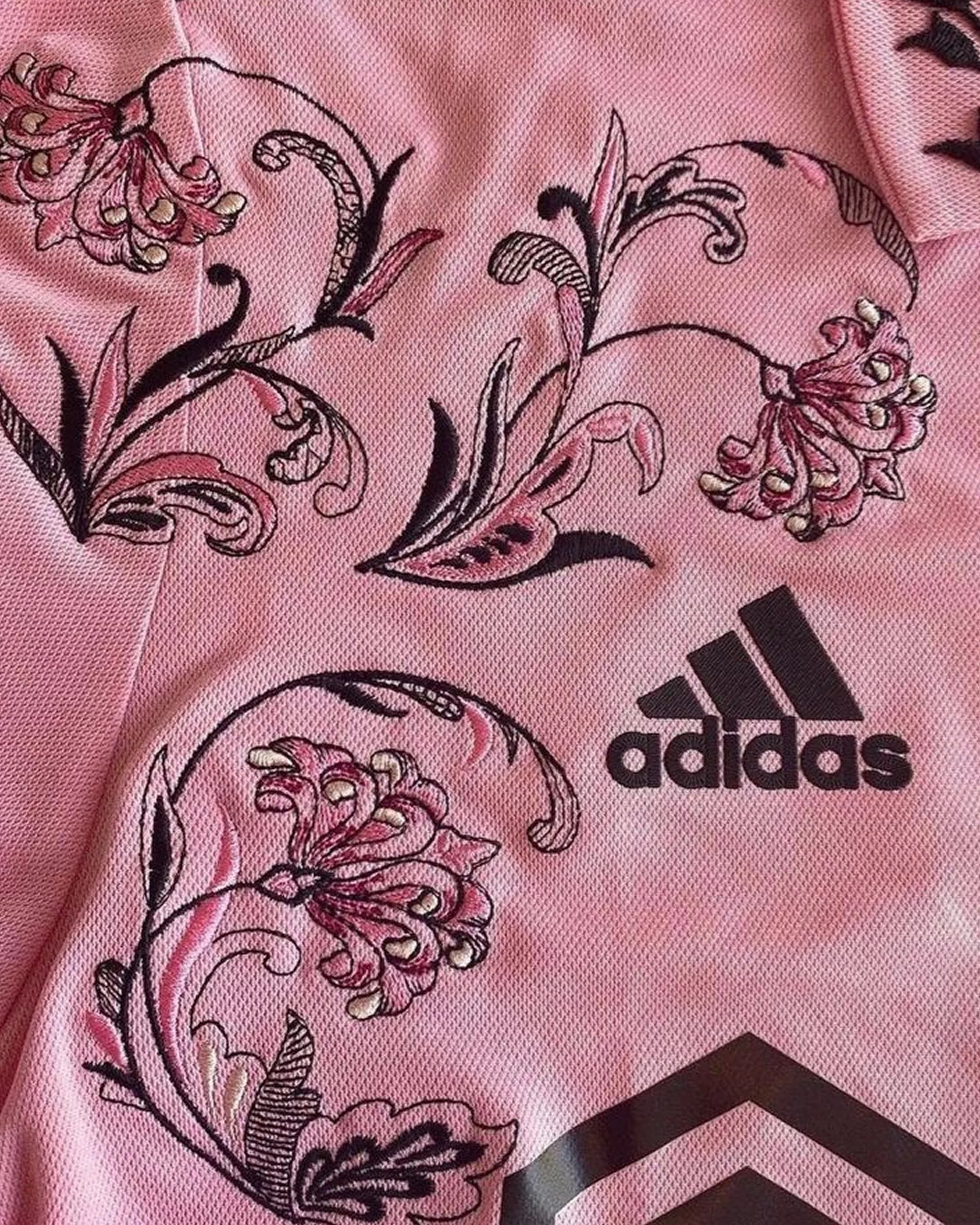 Detailed embroidery on the Inter Miami 'Flower Candy' Edition Jersey highlighting the sports logo framed by botanical threadwork.