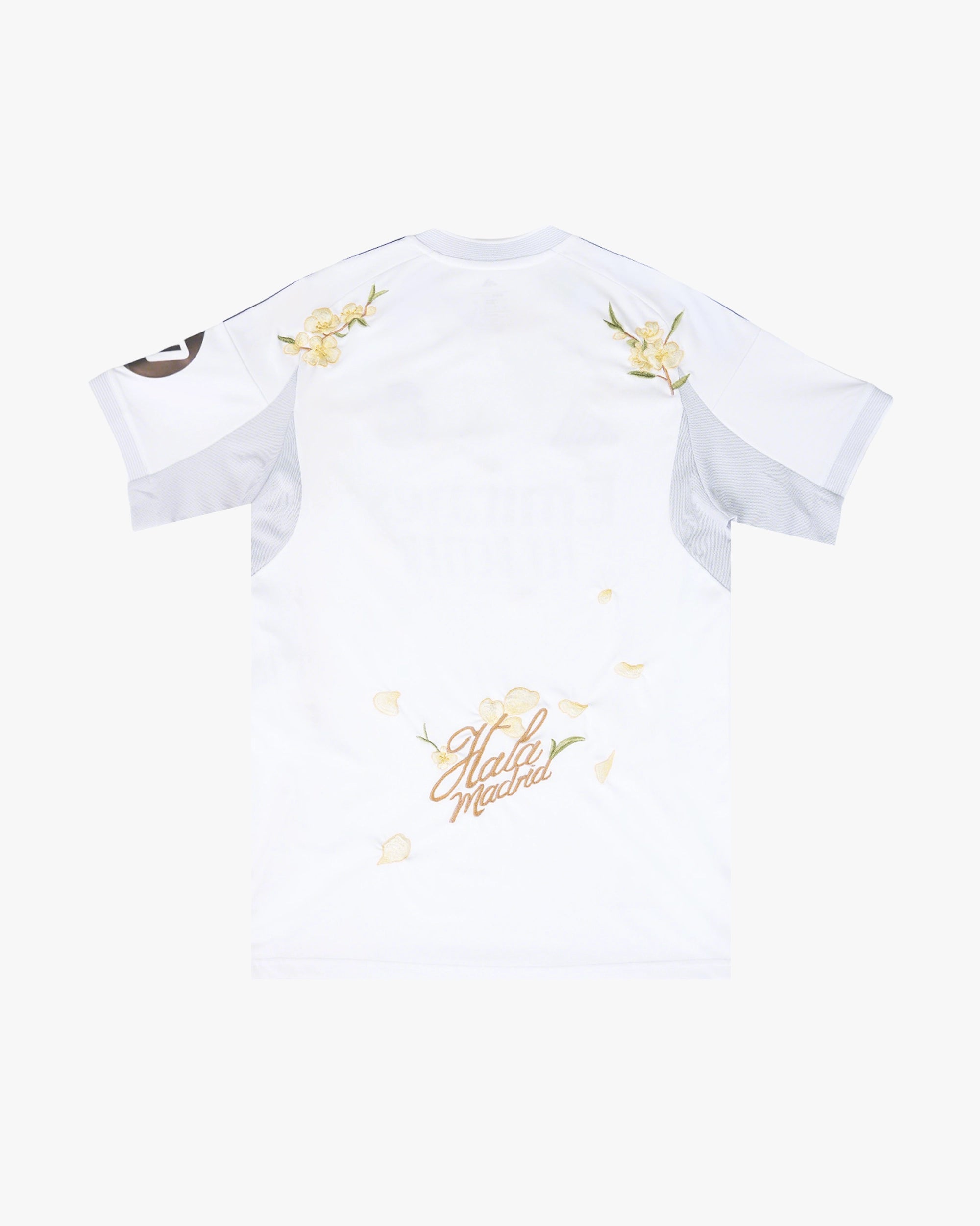 Clean back silhouette of the Real Madrid Embroidered Jersey showcasing the iconic white canvas and gold shoulder stripes.