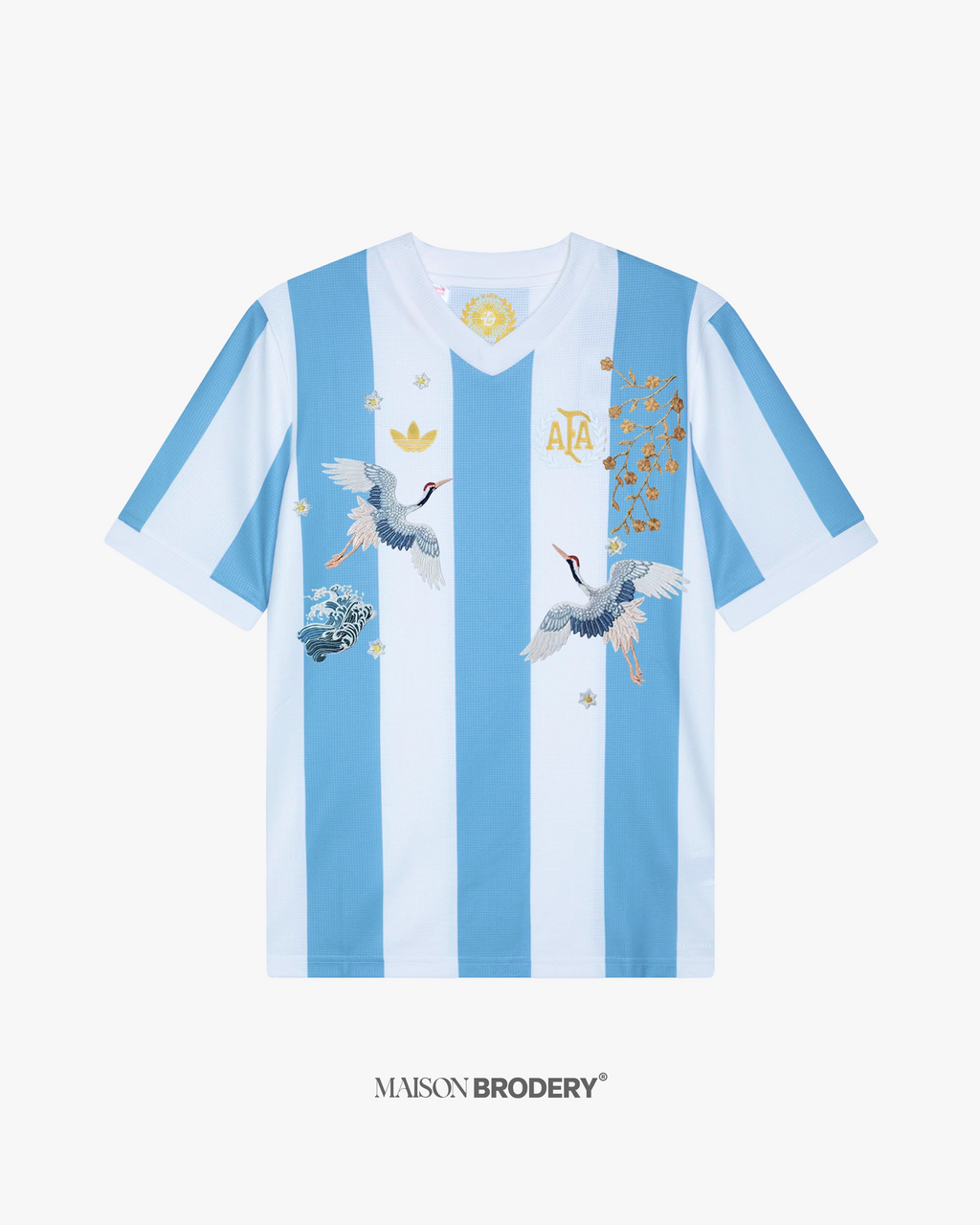 Embroidered Argentina 50th Anniversary front view showcasing cranes, golden blossoms and wave stitching.