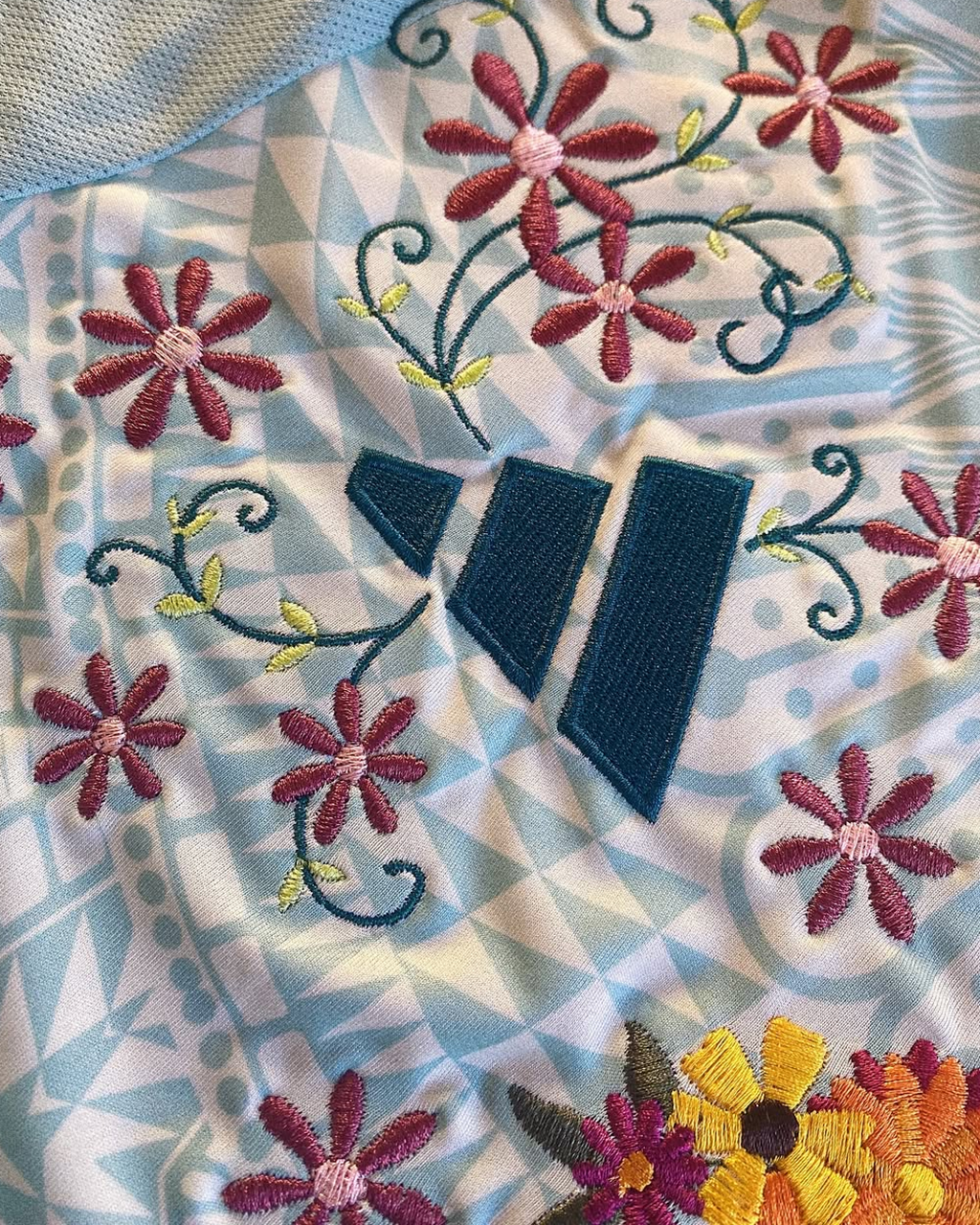 Detailed look at the artistic floral craftsmanship on the Embroidered Mexico Away Jersey 2024-25, adding a unique touch to the classic stripes.