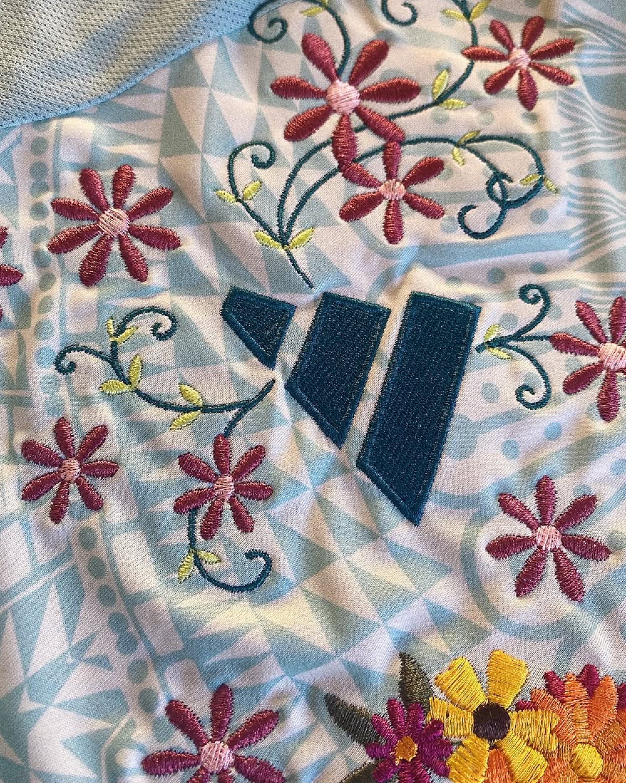 Detailed look at the artistic floral craftsmanship on the Embroidered Mexico Away Jersey 2024-25, adding a unique touch to the classic stripes.