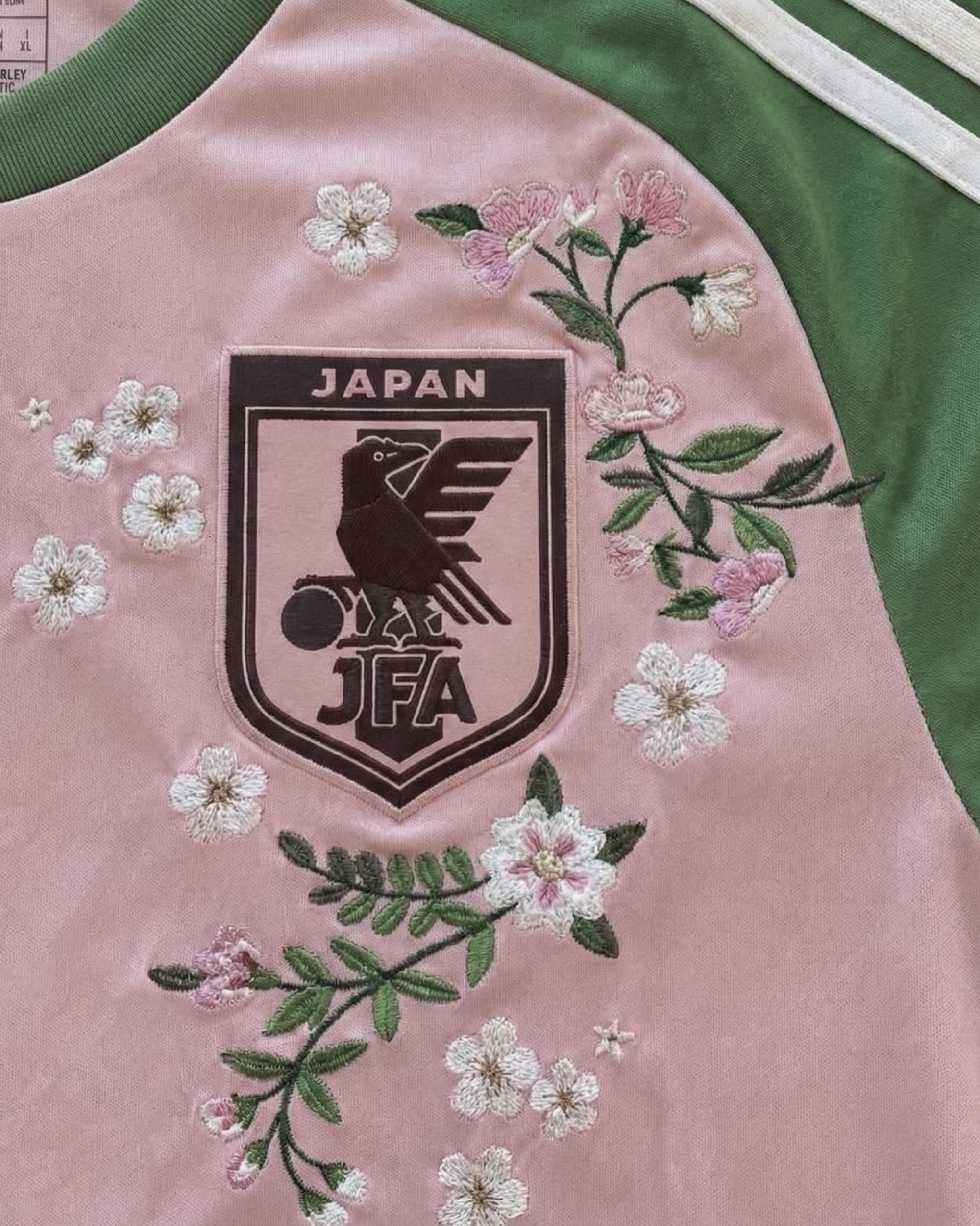 Close-up of the Japan national team badge on the Embroidered Japan x Nigo 2022, surrounded by artistic floral stitching.