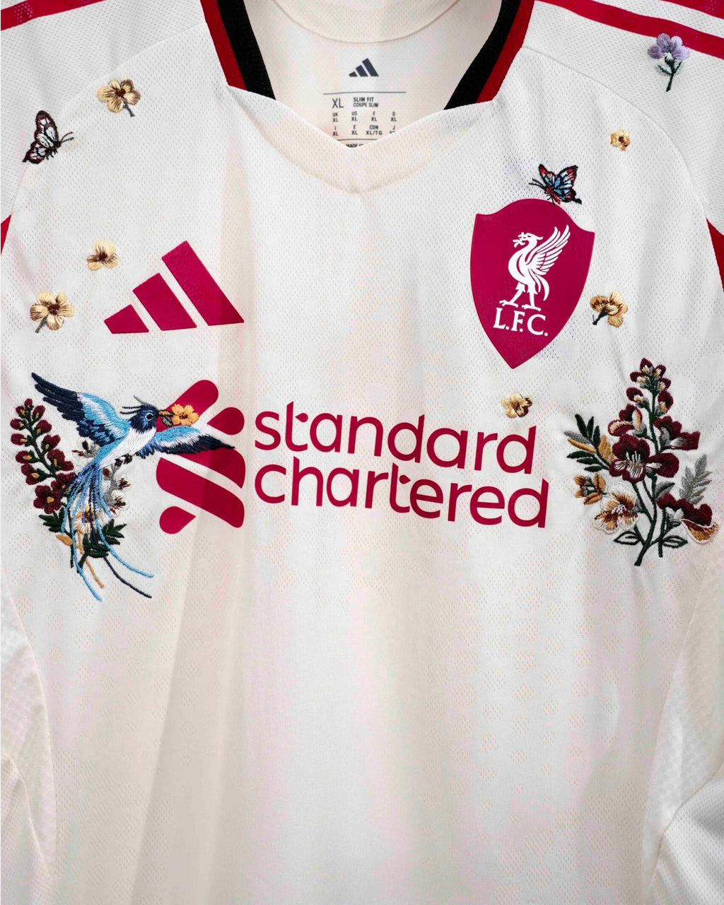 Close-up Of The Liverpool Concept Jersey Long Sleeves Highlighting The Red Rose Stitching Around The Crest And Sports Logo.