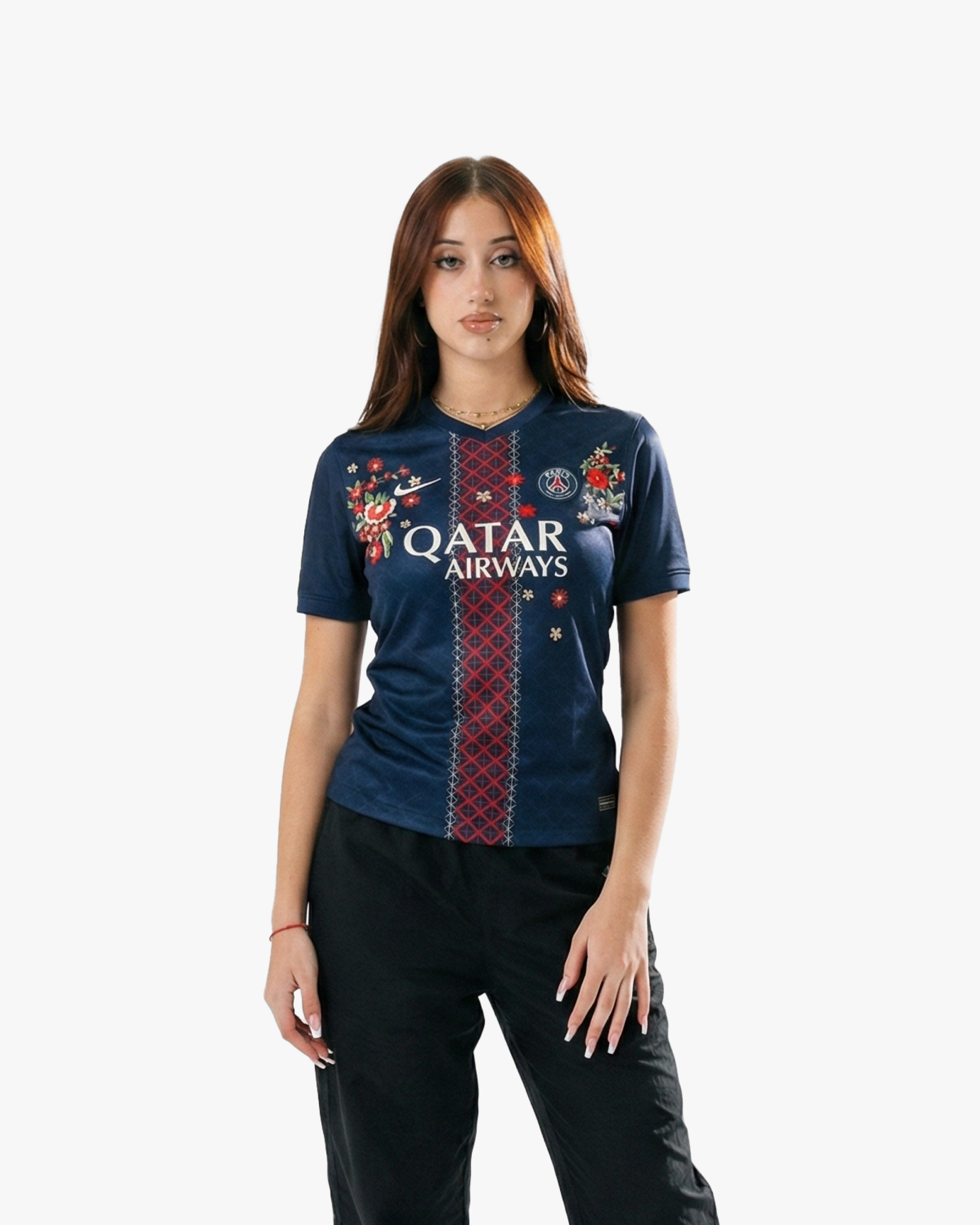 Woman wearing the Embroidered PSG Home Jersey 2025-26 featuring floral embroidery and deep navy tones.