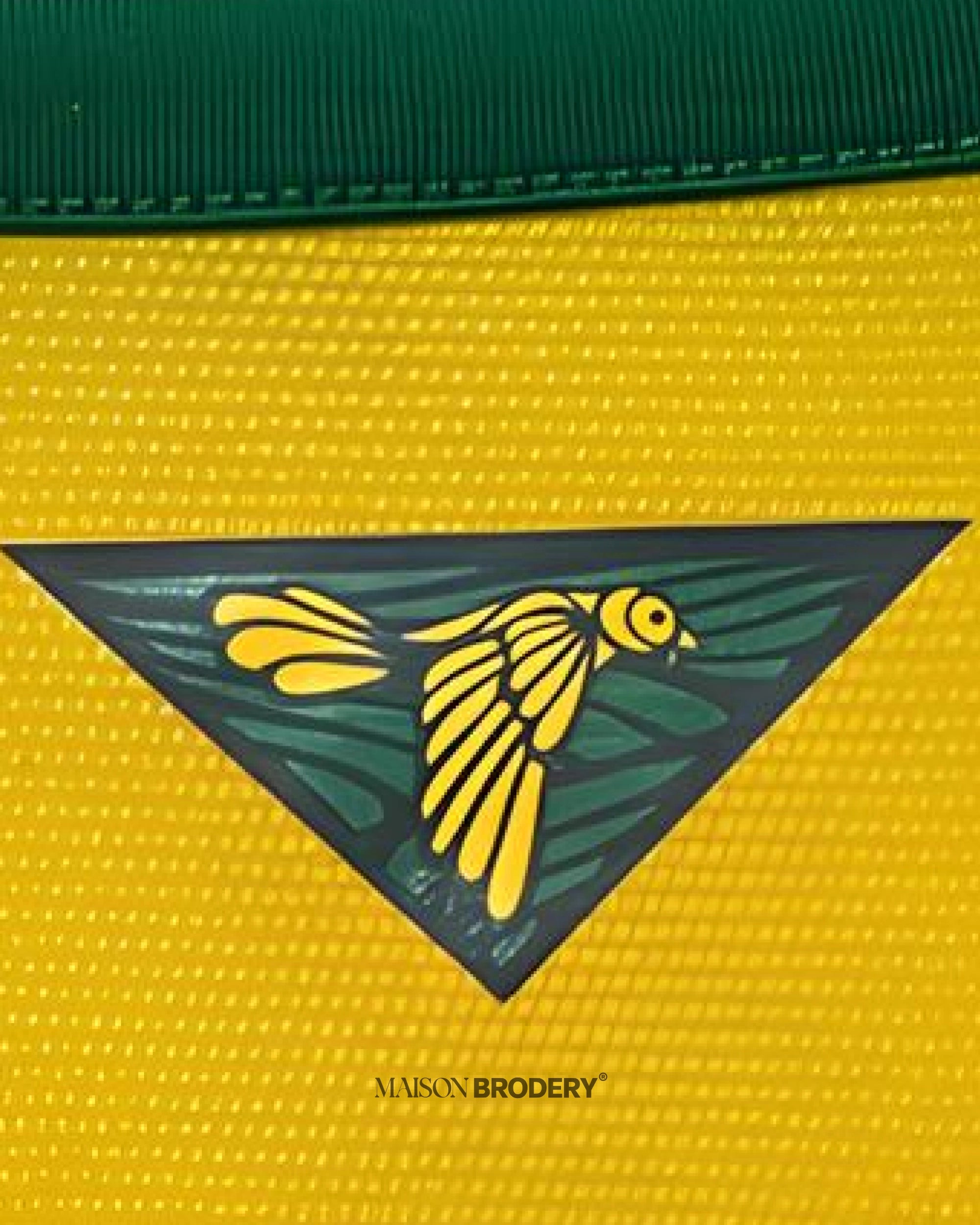 Detail of the design on the Embroidered Brazil Home Jersey 2014 featuring a vibrant yellow and green emblem.
