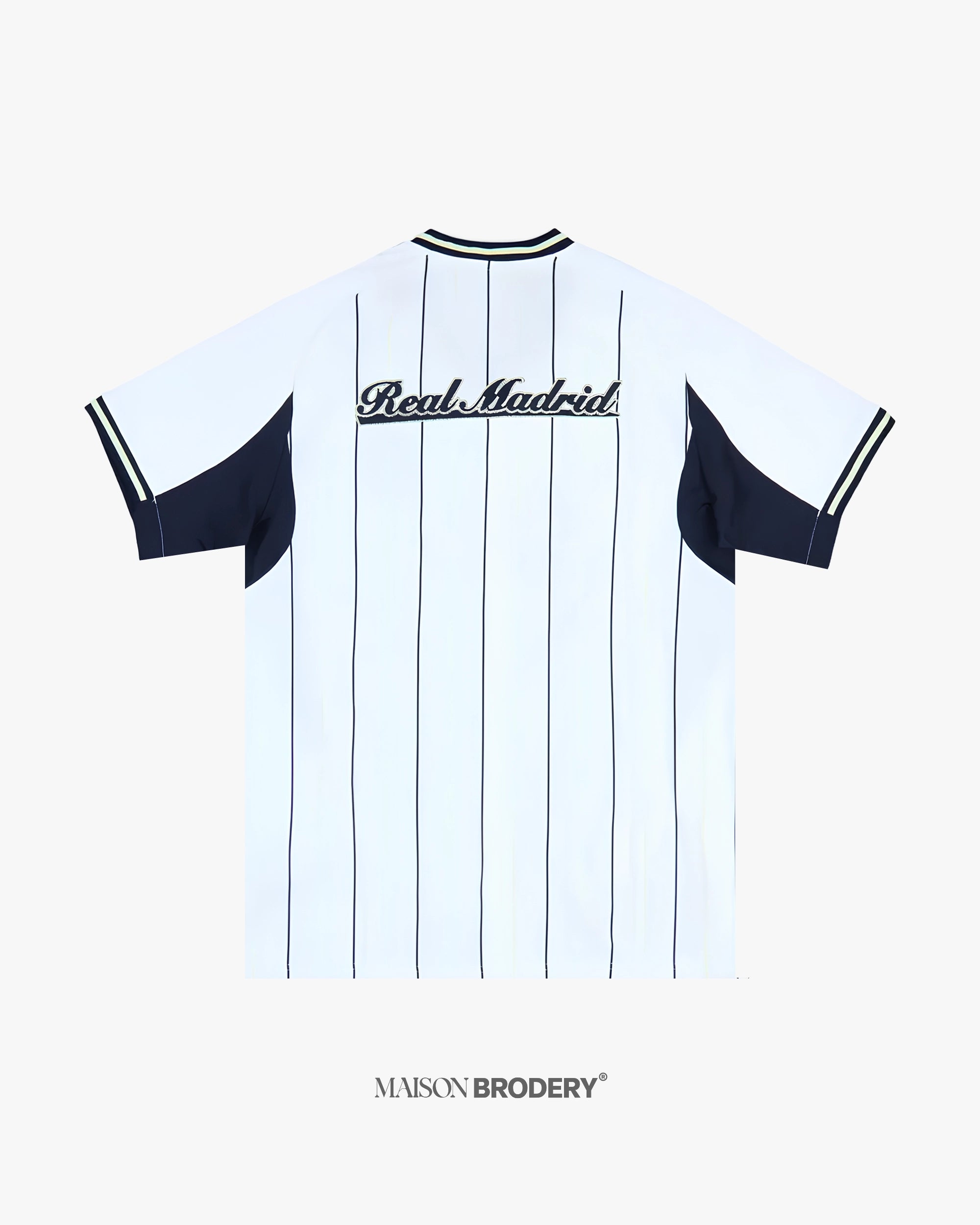 Embroidered Real Madrid US Pack back view highlighting vintage script embroidery and clean pinstripe layout.