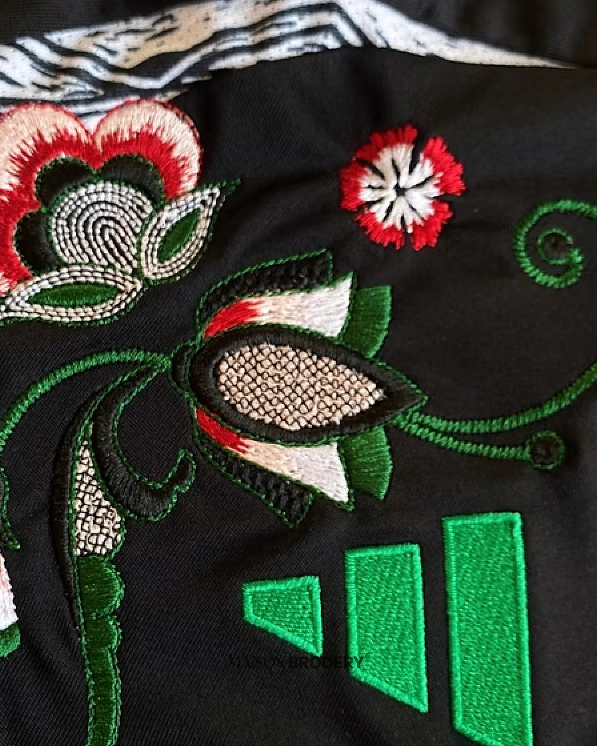 Close-up of floral embroidery on the Embroidered Arsenal Away Jersey 2024-25, showcasing intricate designs and vibrant colors.